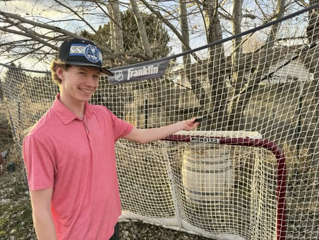 Avery showing he hit the puck so hard it went through the net.