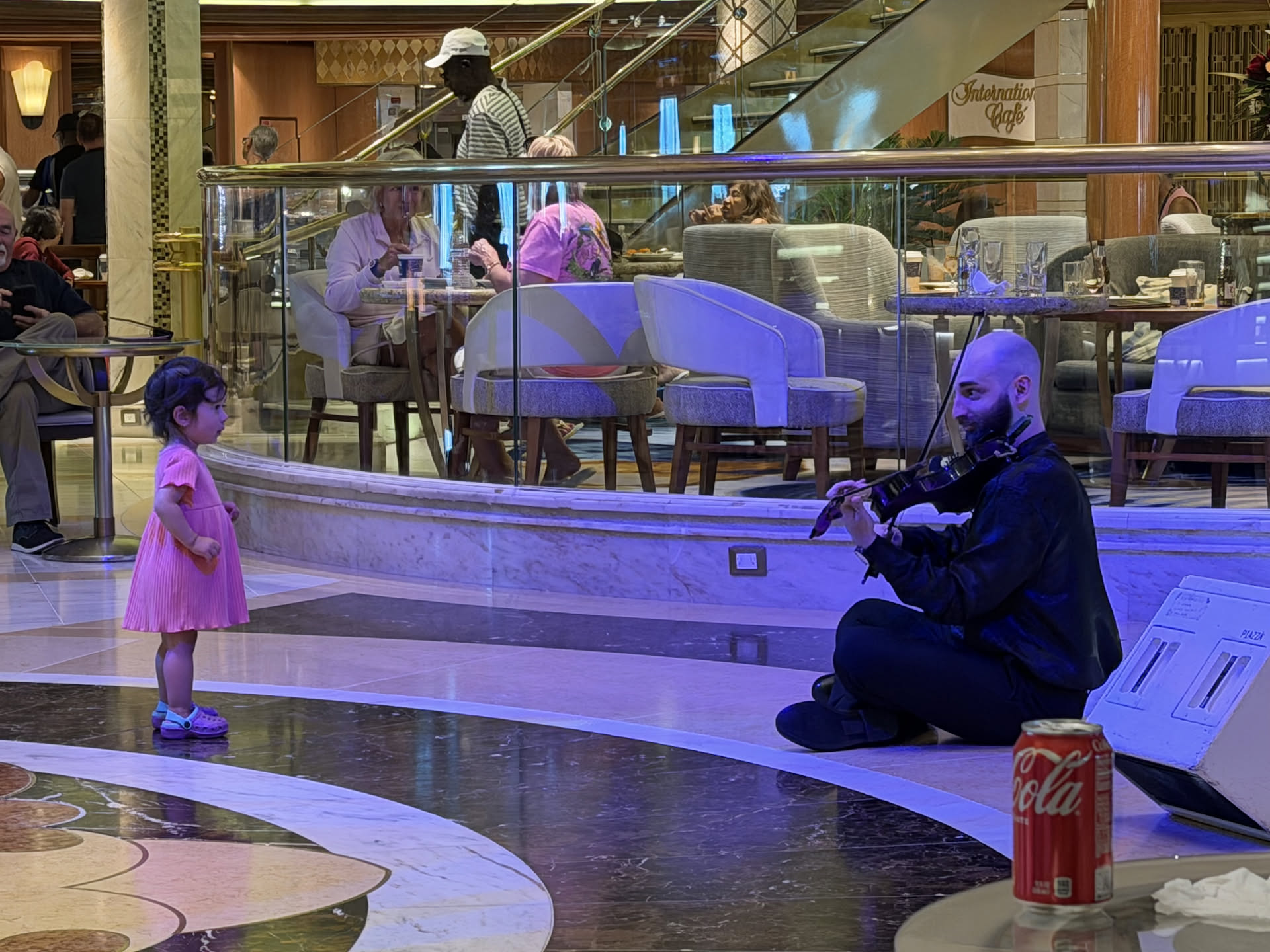 The violist sat on the floor in front of a little girl and played