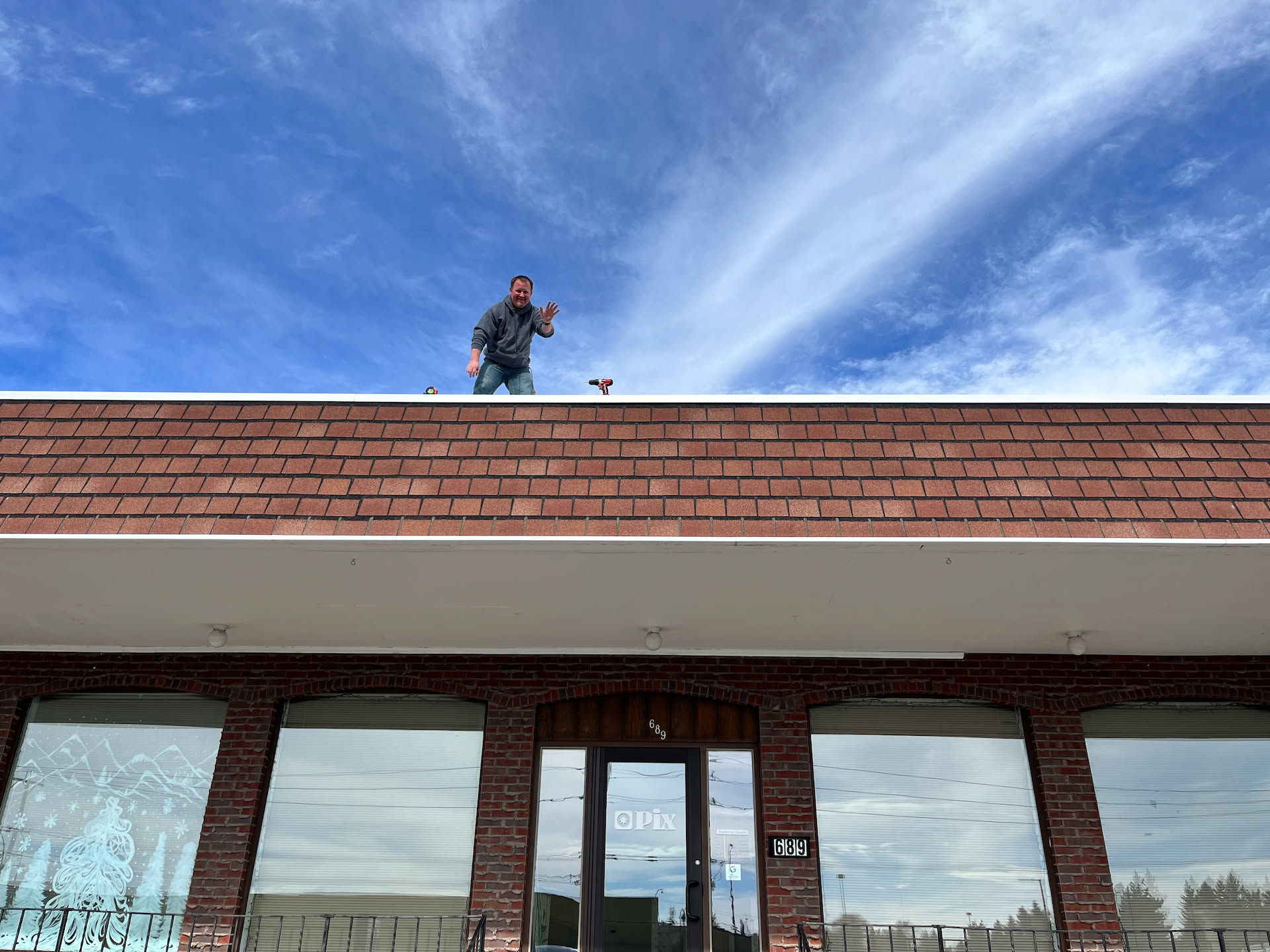 Over our lunch break, we headed down to Pix to put up the new banner. Nick did all the high stuff.