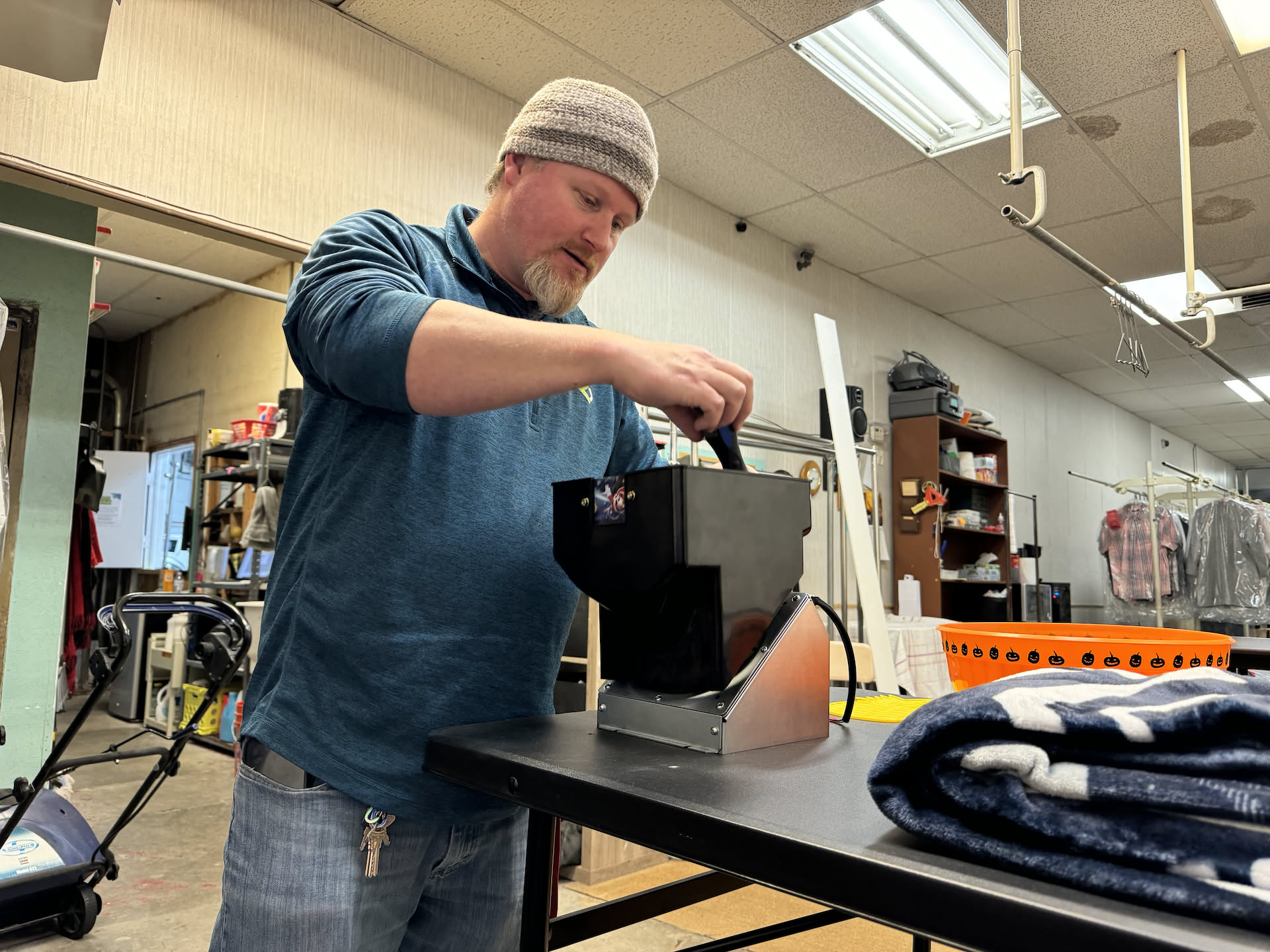 When Nick got back to the laundromat, he was bombarded with multiple issues. Here he is working on the change machine that decided to stop counting, and after that he had to fix trim that was falling on customers… so much fun.