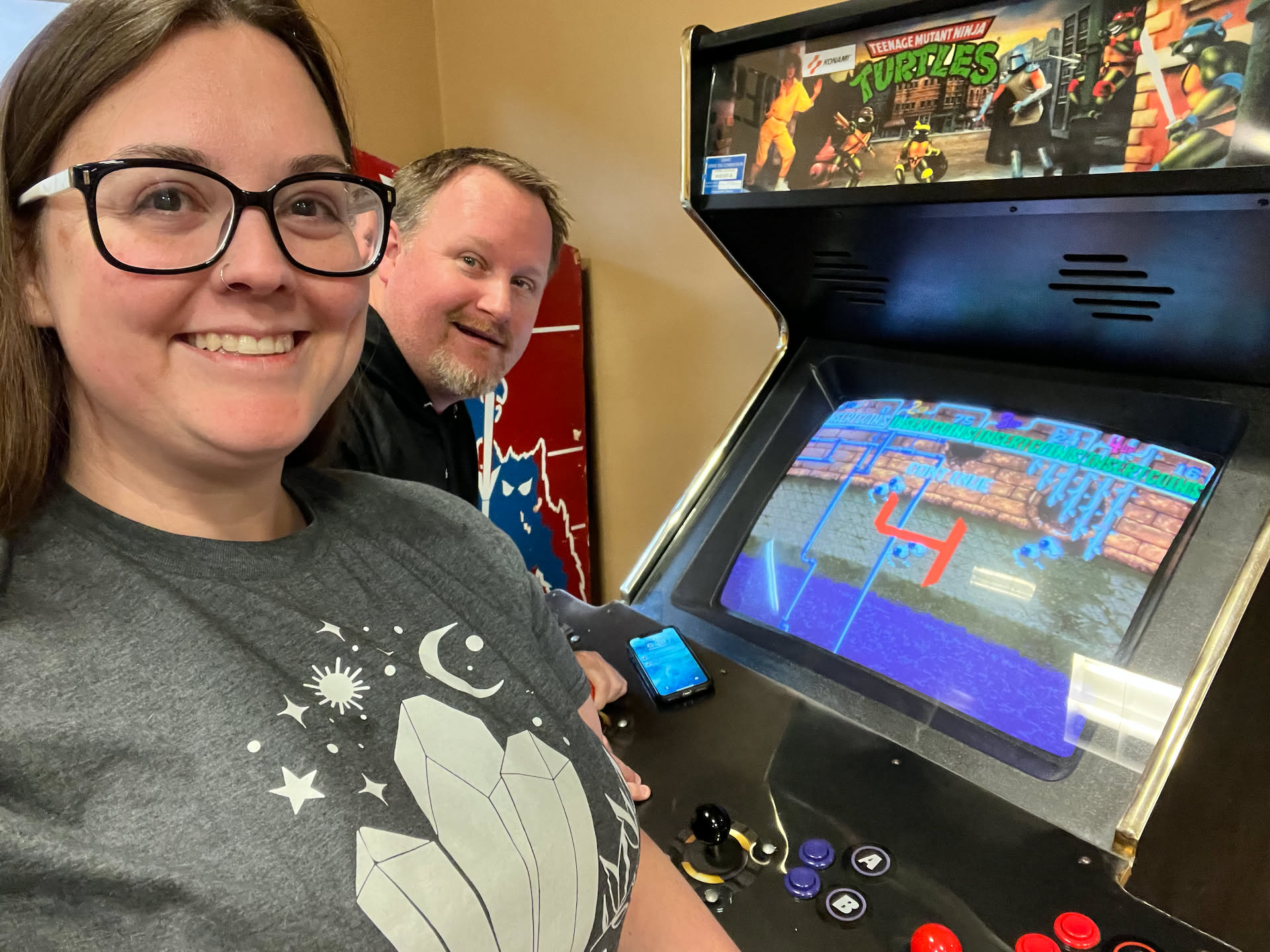 After dinner, we got to the theater a little early, so we spent some time playing Teenage Mutant Ninja Turtles in the arcade.