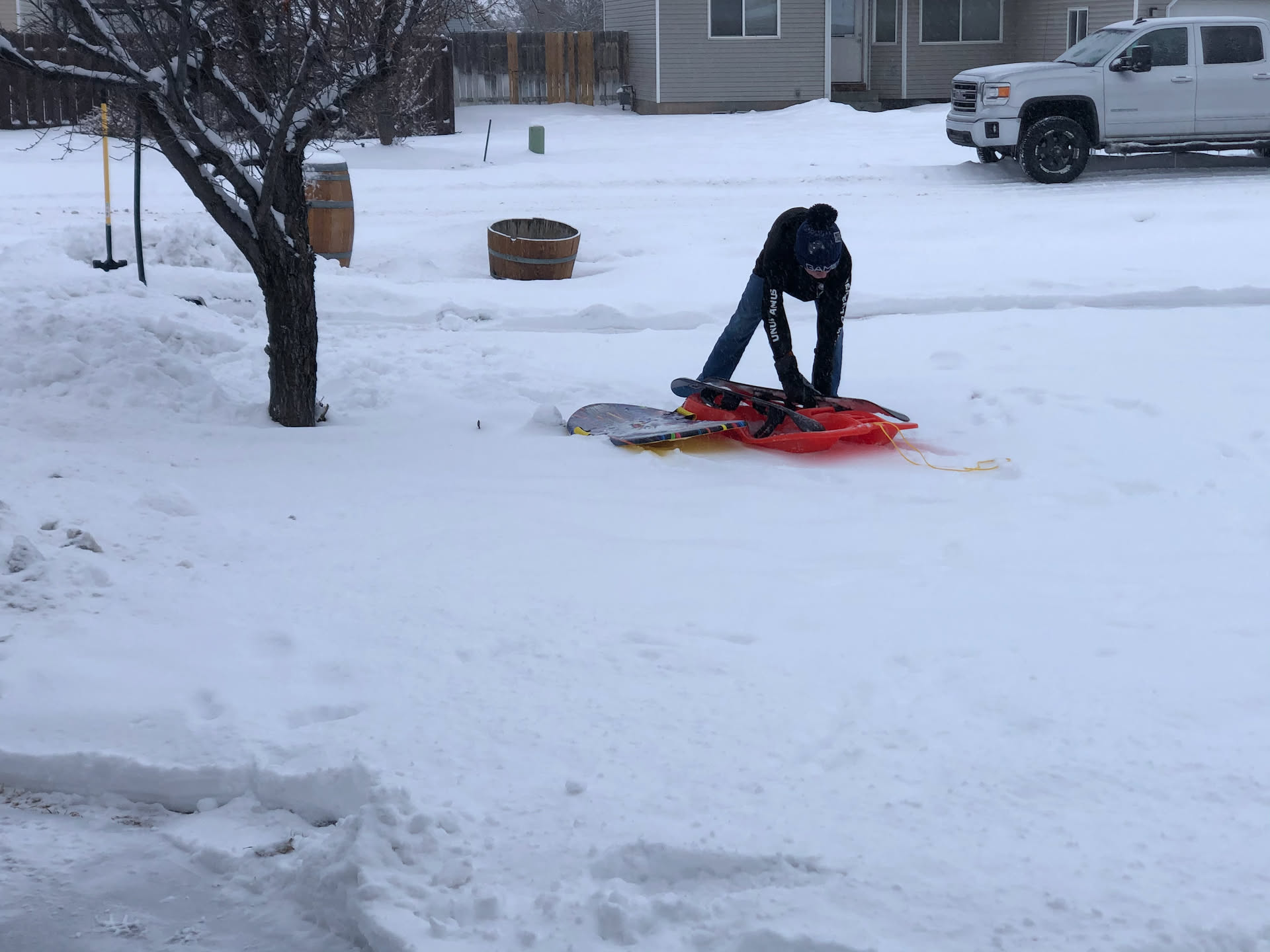 Avery and Nick went out to tackle the snow – the snowblower is fixed, so him and I made quick work of it. Here he is digging out the sleds from the piles of snow.