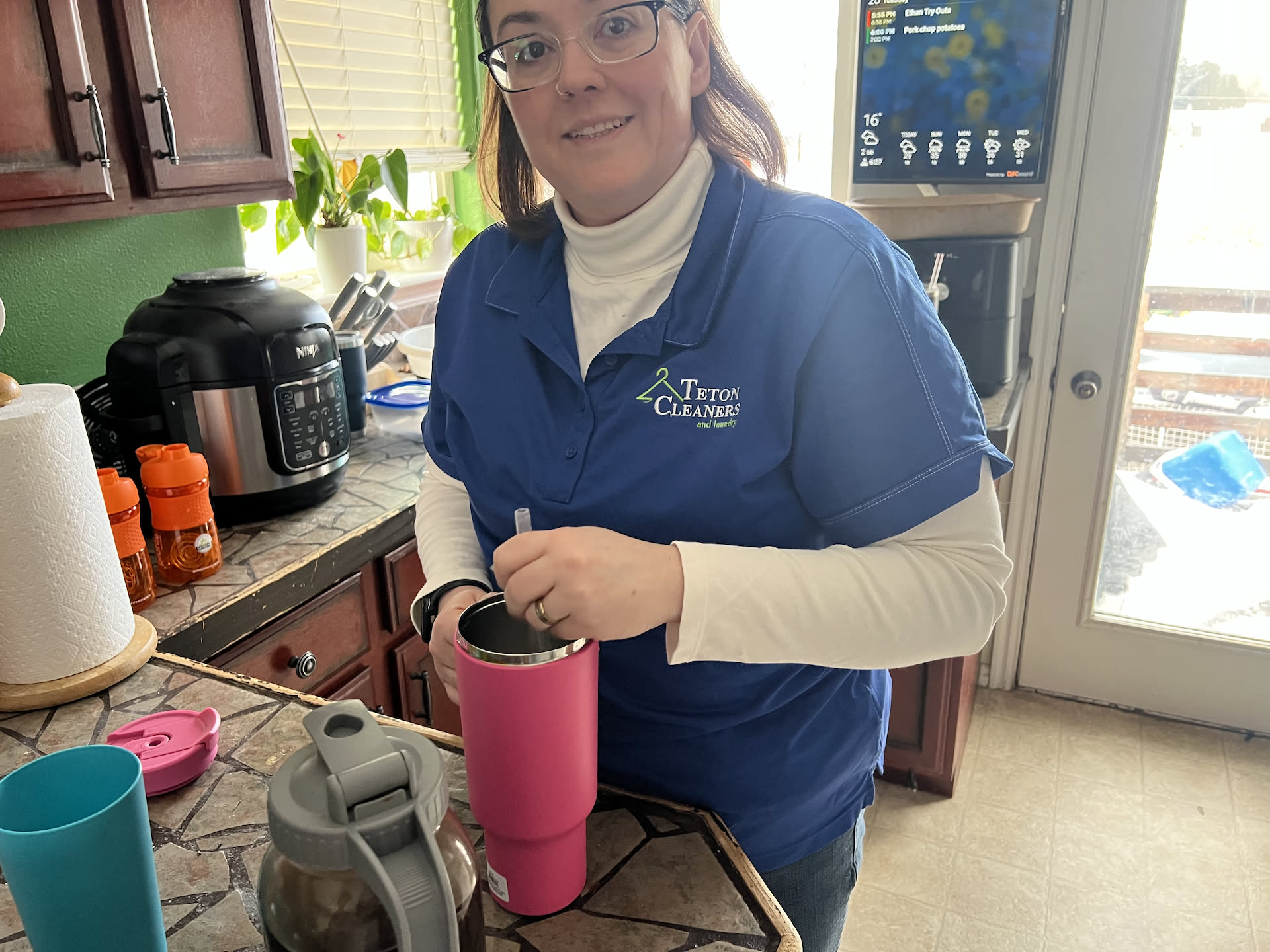 Deanna making up her morning iced coffee to take.