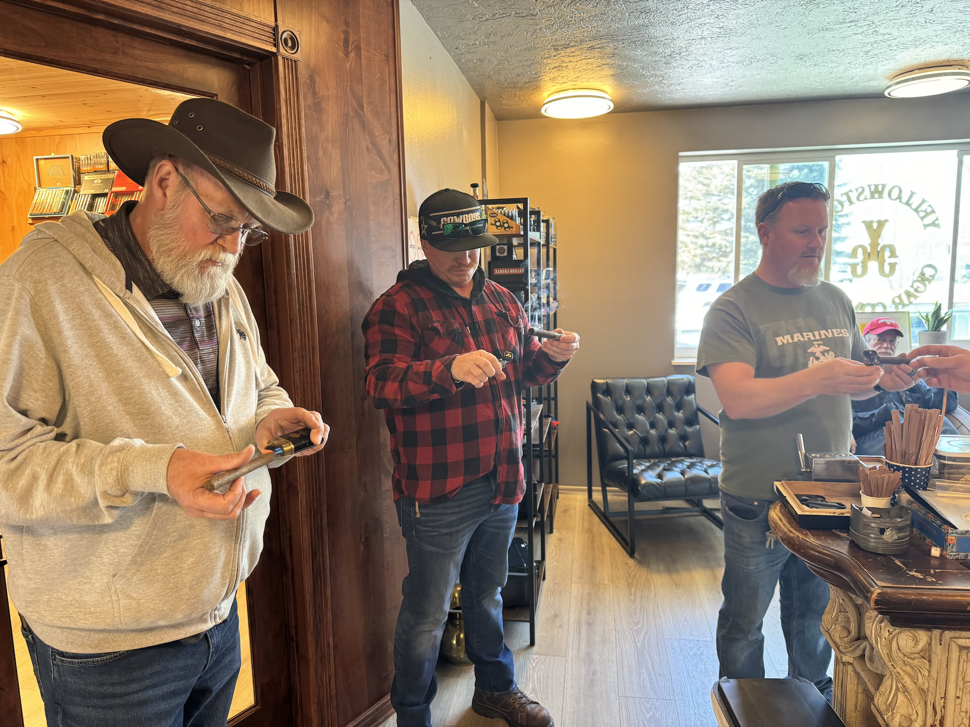 Here we are lighting the cigars we picked, the way he showed us.