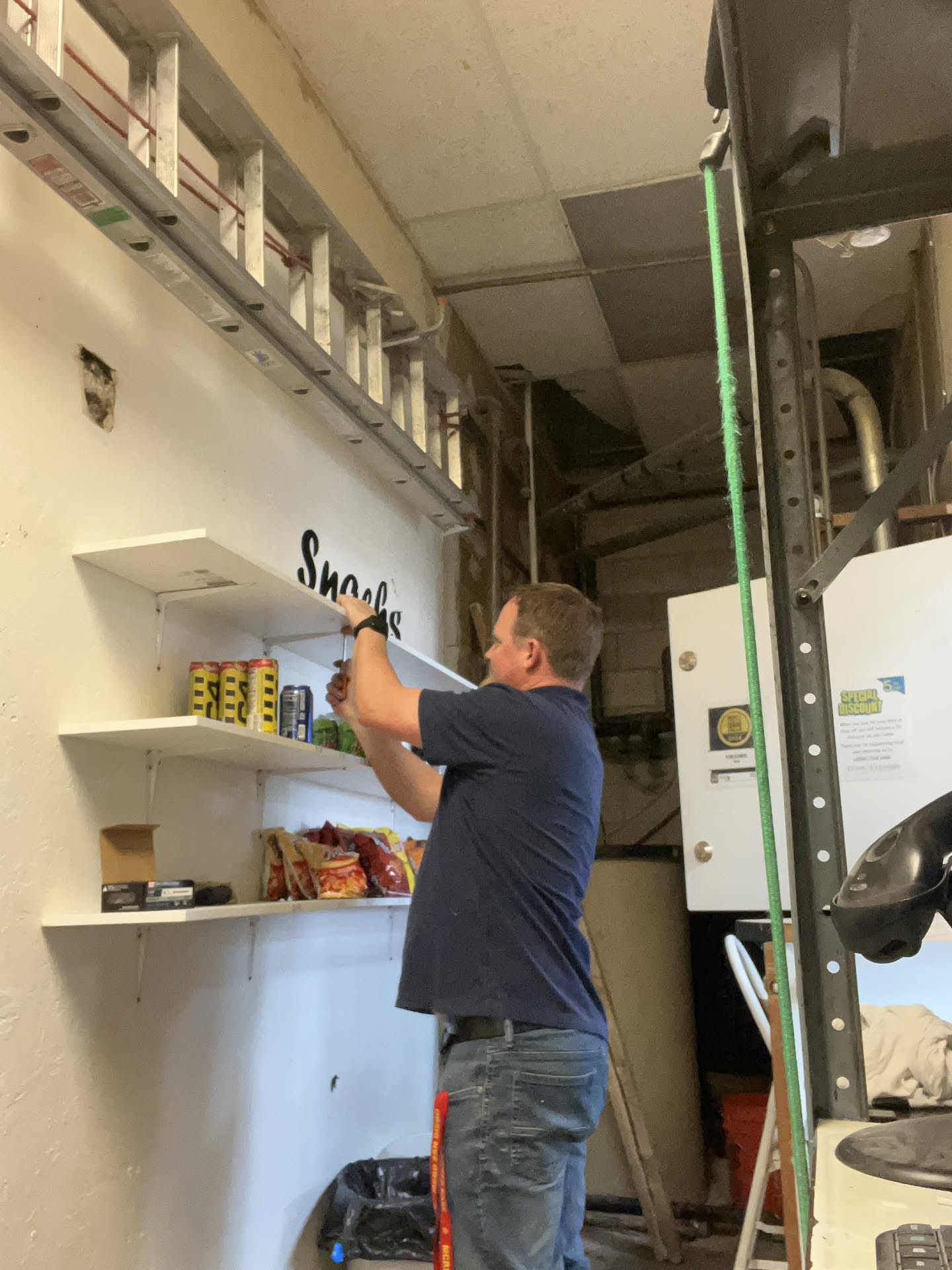 When Nick got done with the run, He stopped in and bought a bunch of laundry supplies to sell, which meant he needed to put up a new shelf.