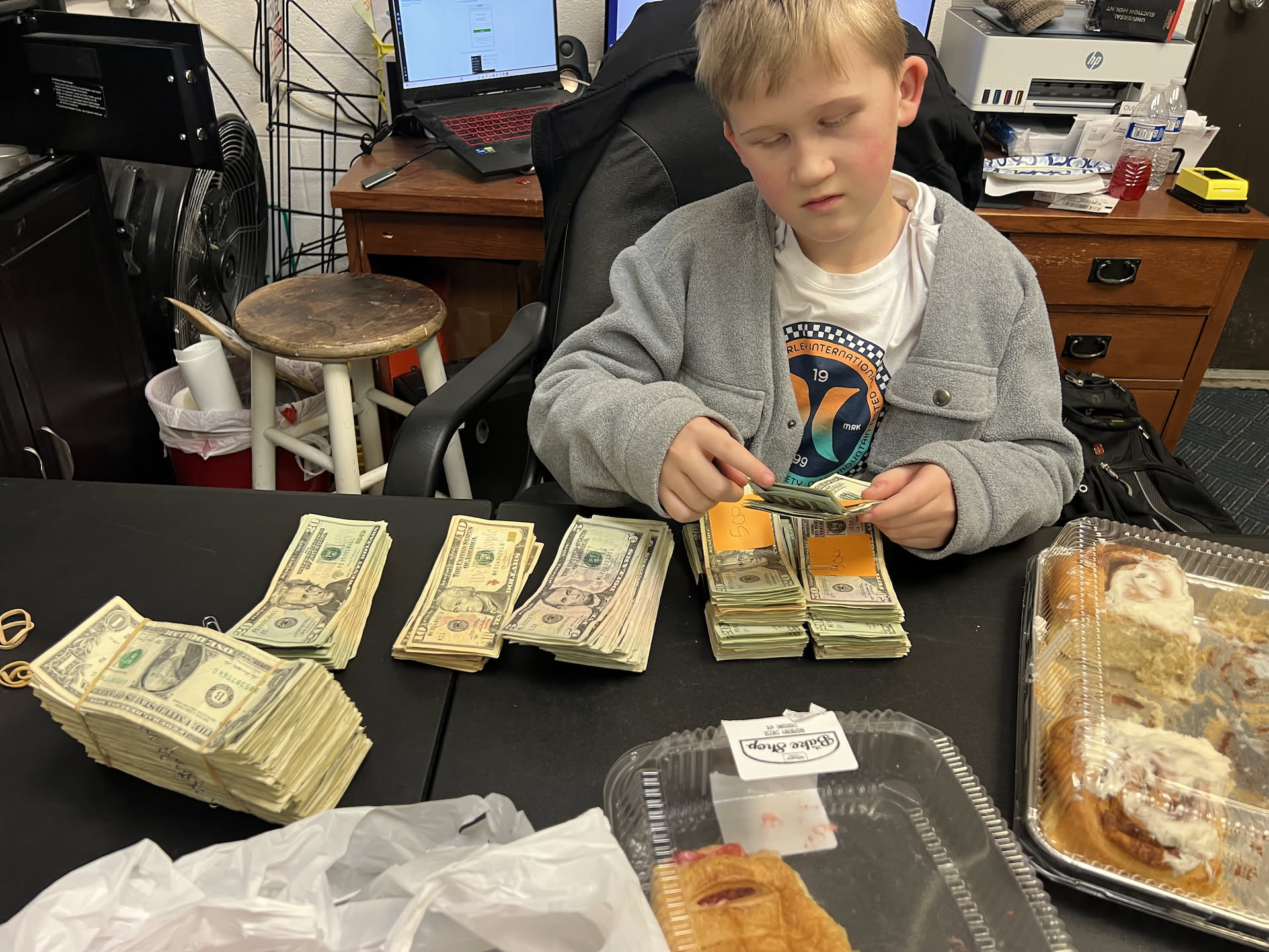 Nick was straightening up the money from the laundromat, and Ethan wanted to pose with it.