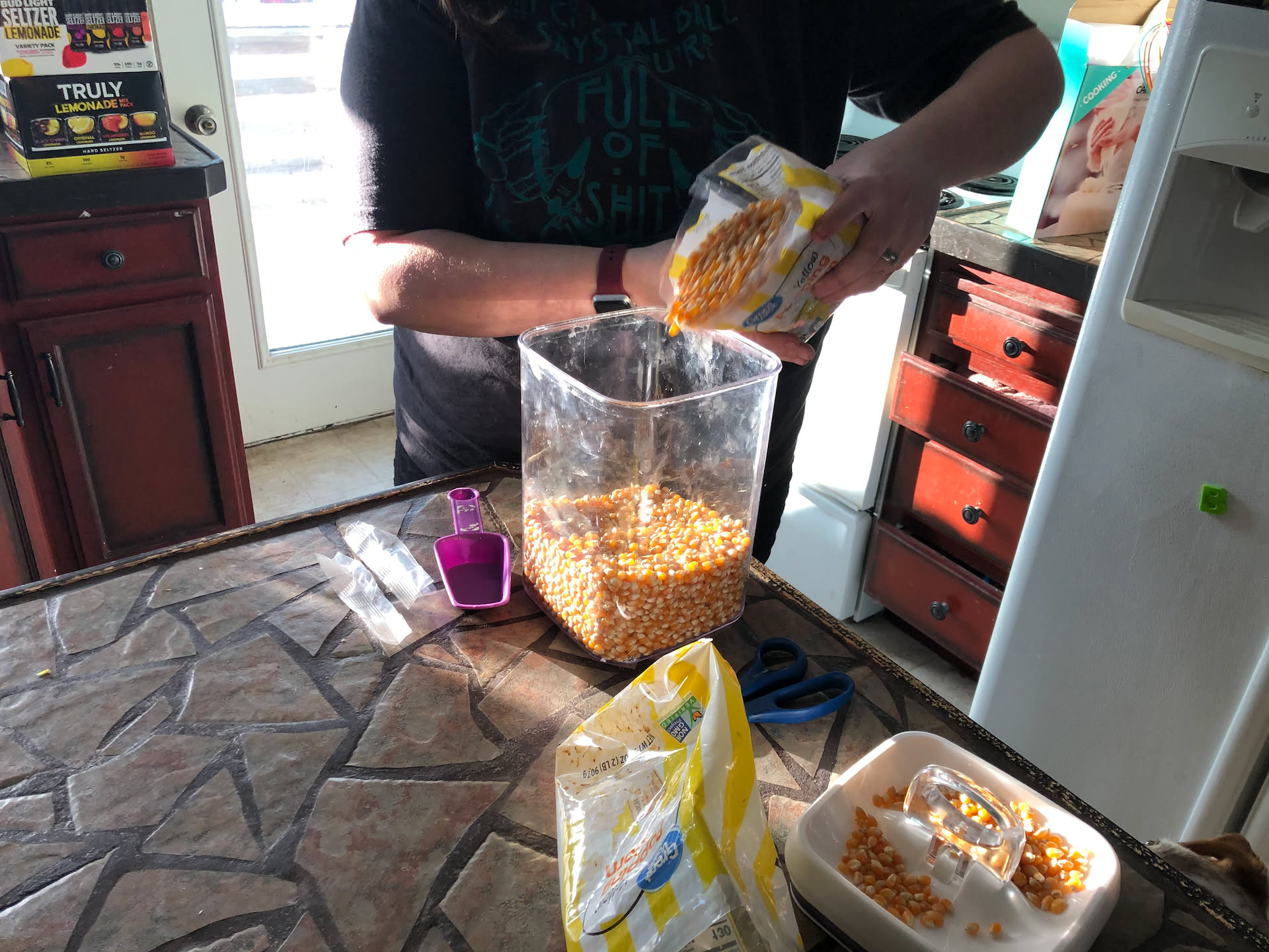 We also got more popcorn… Deanna is refilling our popcorn container… we love popcorn in this house.