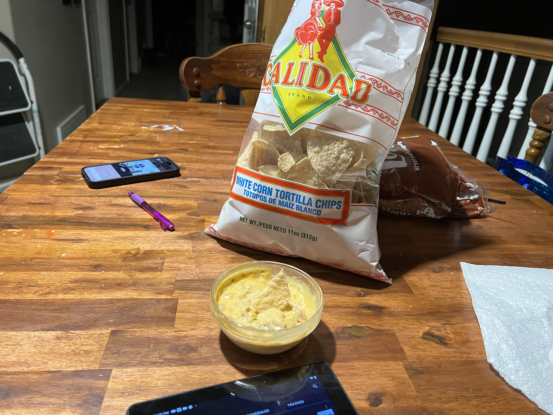 Nick got home late because of the Laundromat, and having chips and dip for a snack before bed.