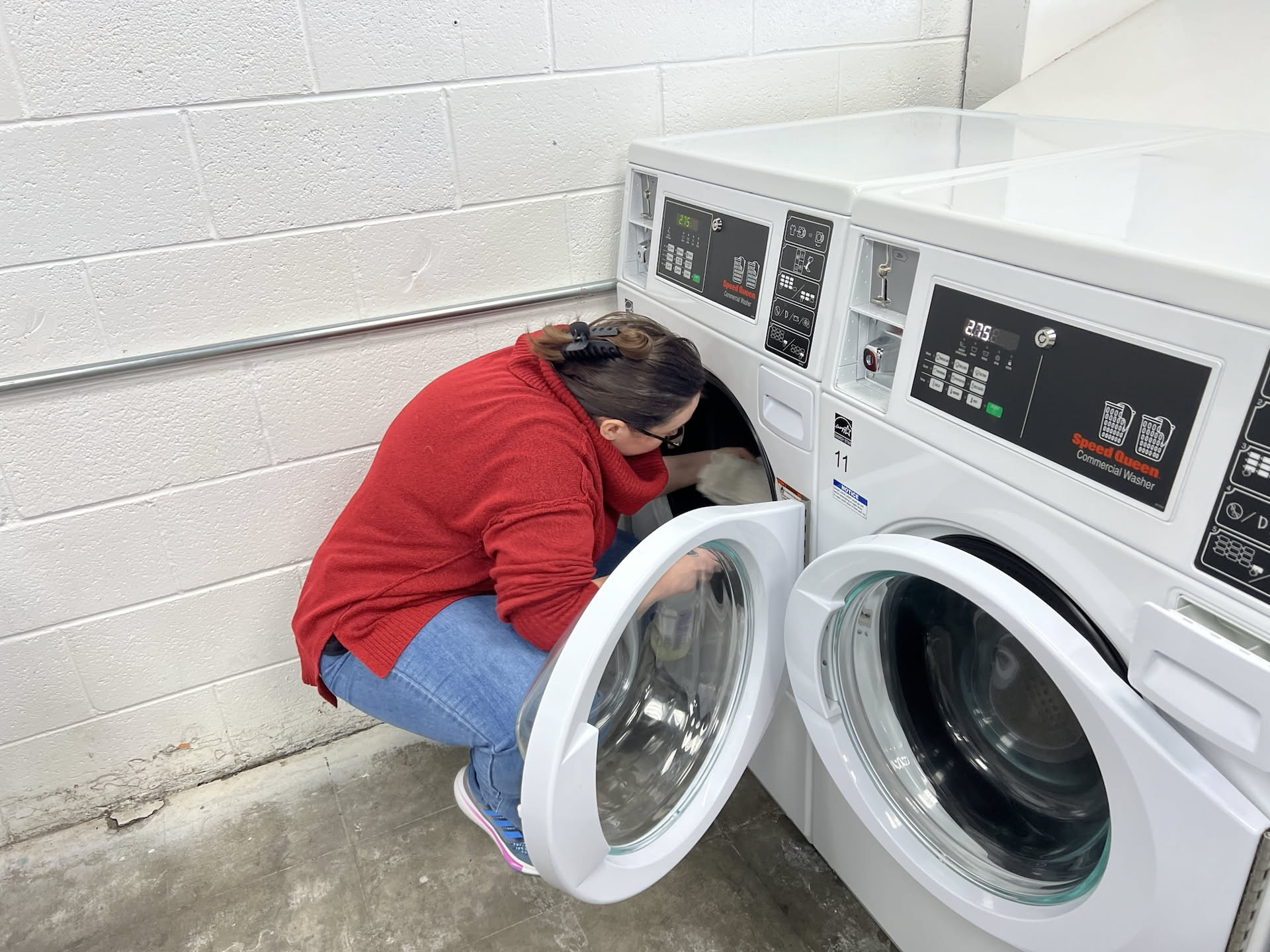 Deanna working hard at the laundromat. We clean and disinfect between every wash.
