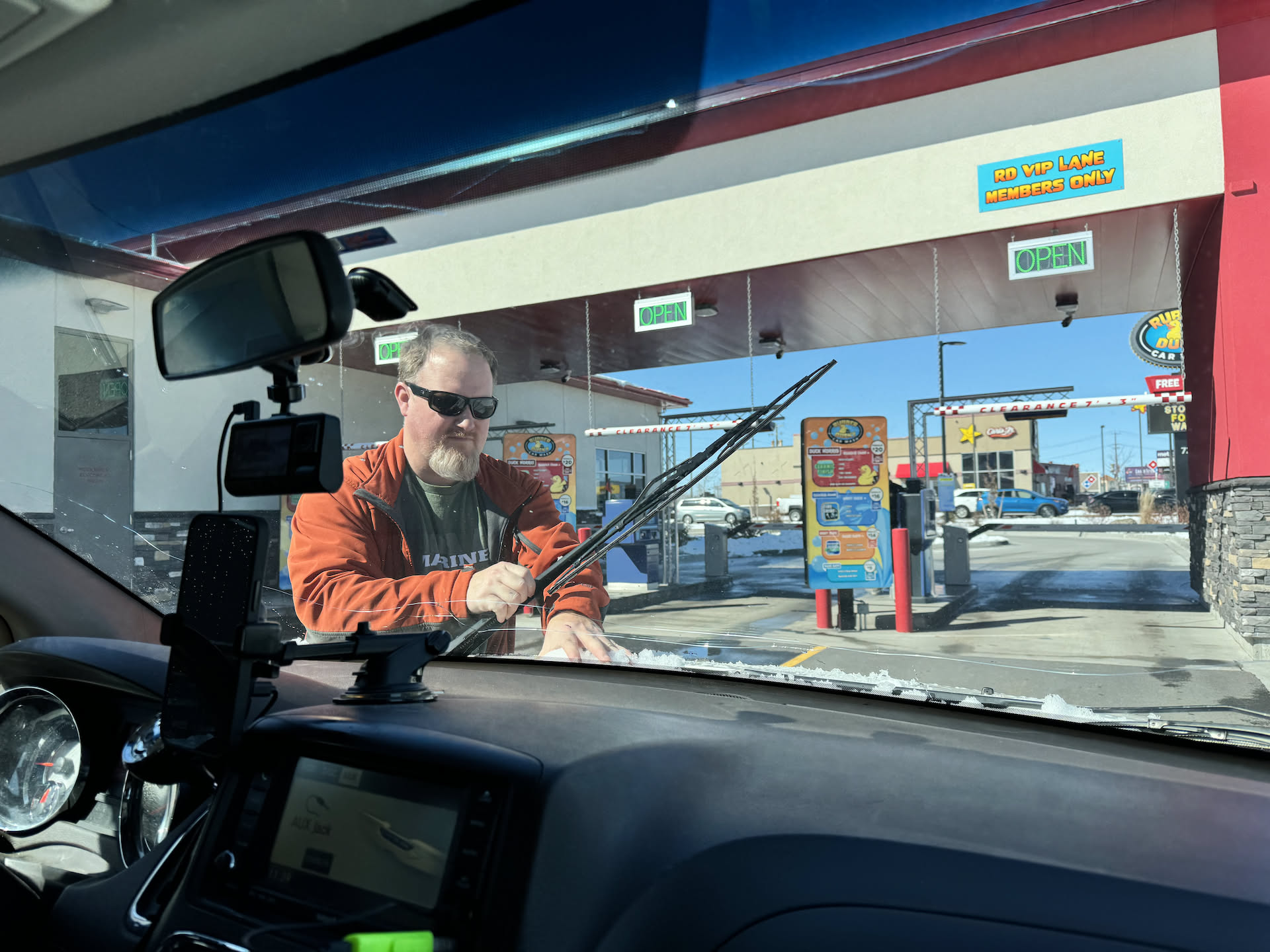 Nick pulling some of the ice off the van before running through the car wash.