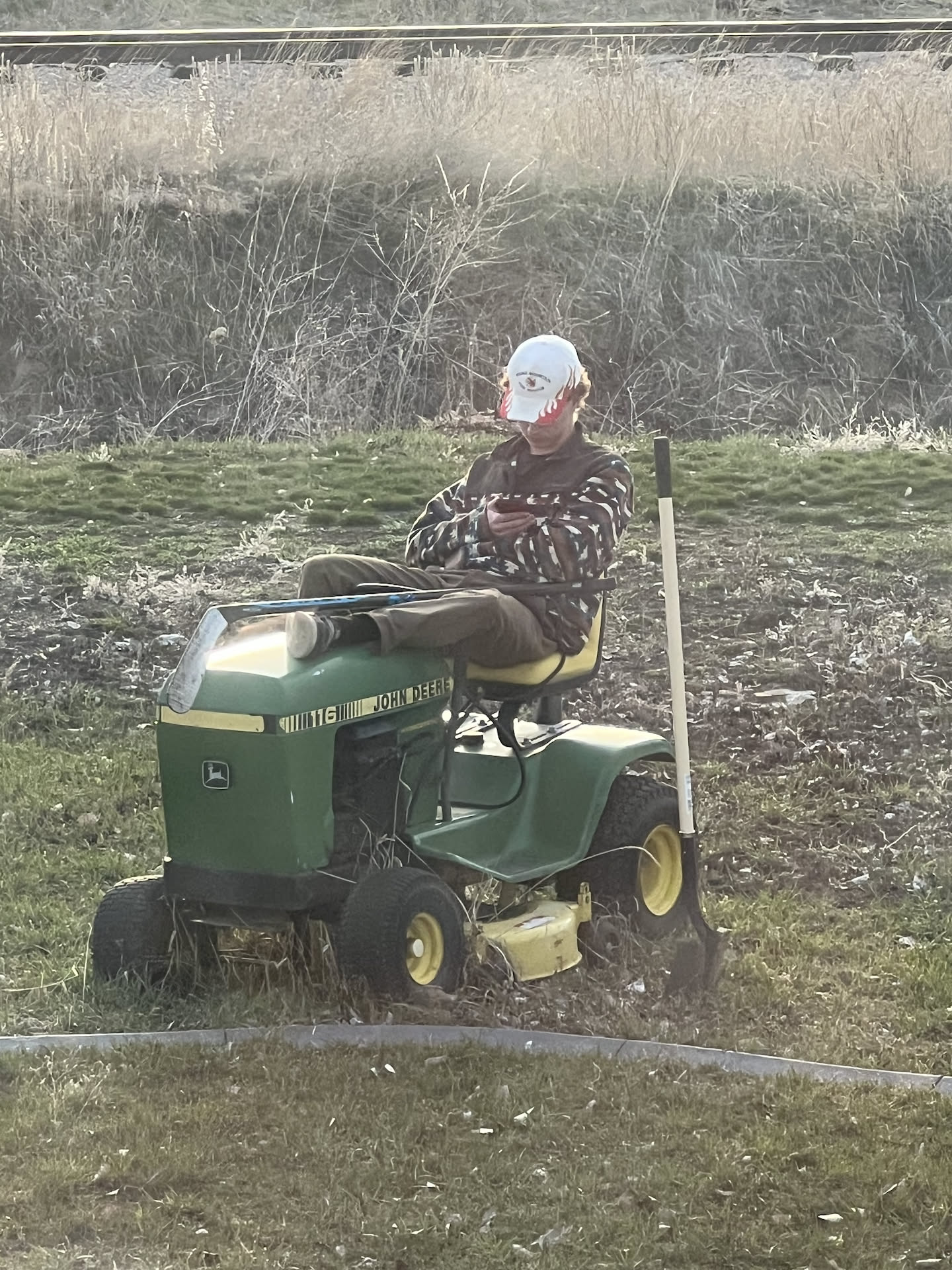 Avery was out playing with is hockey stuff and took a break, Nick caught him sitting on his tractor.
